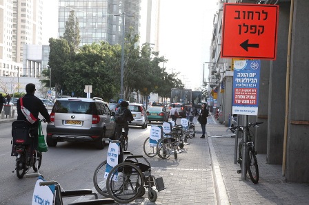 Dozens of wheelchairs occupy parking spots on 4th street in Tel Aviv for a few long hours