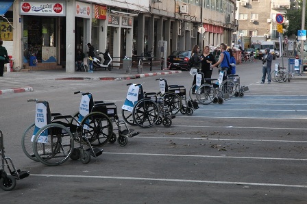 Dozens of wheelchairs occupy parking spots on 4th street in Tel Aviv for a few long hours