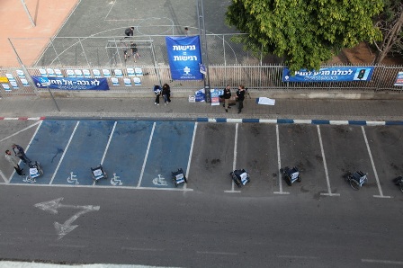 Dozens of wheelchairs occupy parking spots on 4th street in Tel Aviv for a few long hours